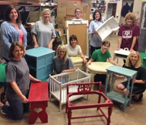 Attendees of Hardin True Value’s chalk paint workshop, which is taught by co-owner Brenda James, display their finished pieces.