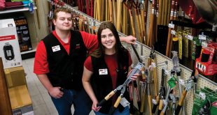 Two young employees in a hardware aisle
