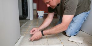 Man installing a tile floor
