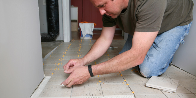 Man installing a tile floor