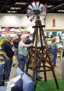 Man at Do It Best Market looking at a windmill