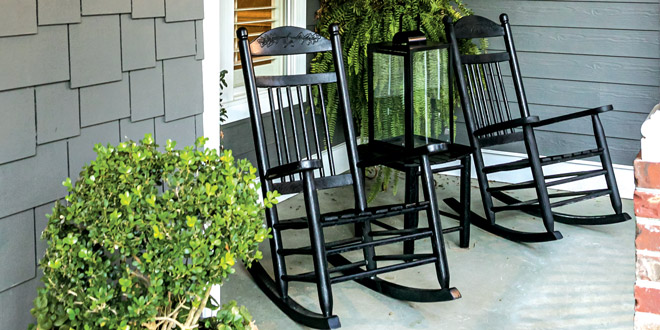 Black rocking chairs on a front porch